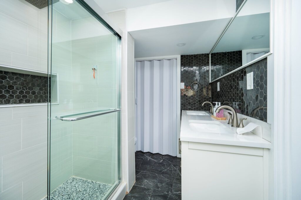 Dual sink vanity with ample storage and modern lighting in a Mo Reno Ottawa bathroom renovation.