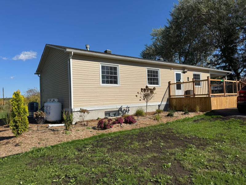 Completed home addition project by Mo Reno in Ottawa, showing new second-story construction and seamless exterior blending.